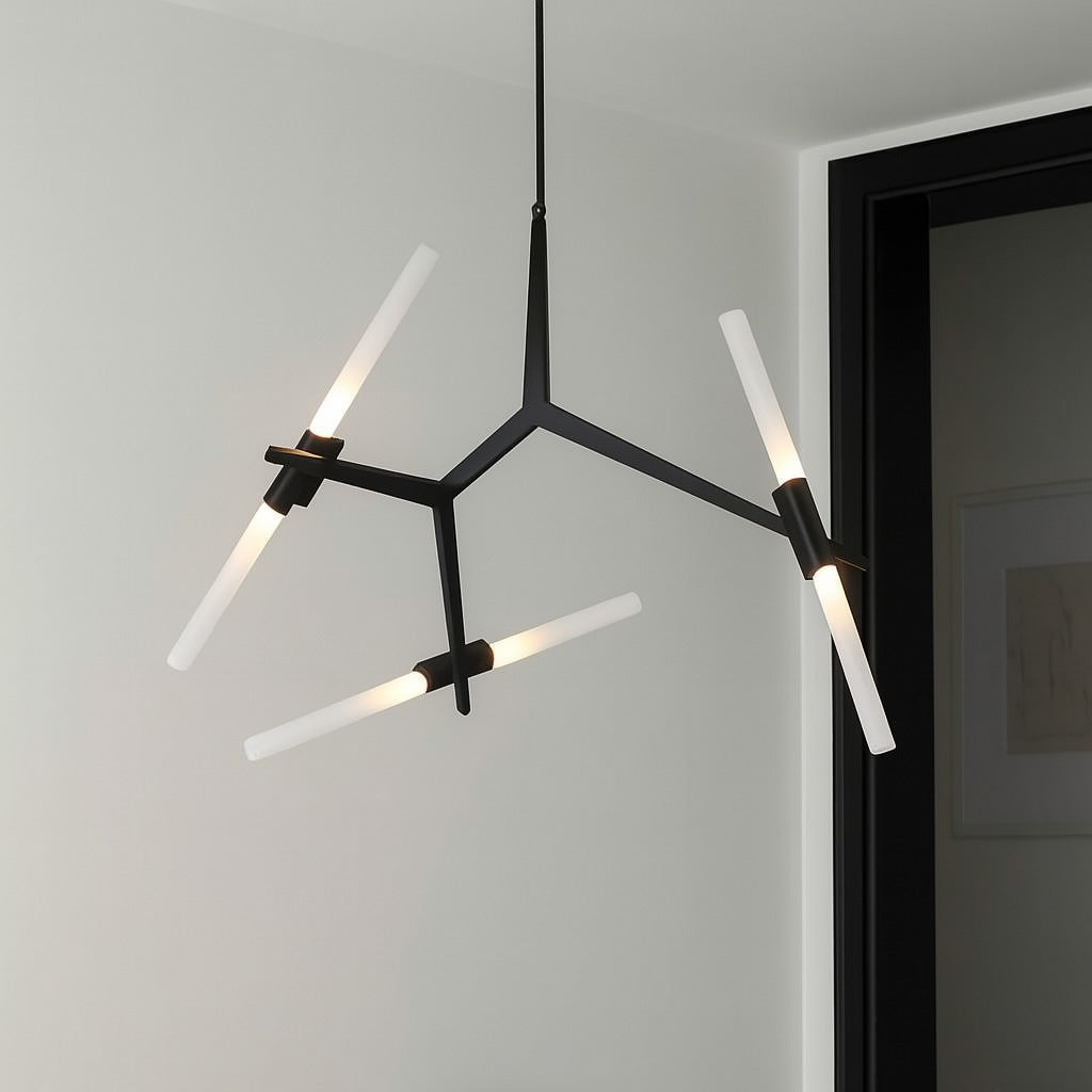 Modern black chandelier hanging above a white marble table with black chairs.