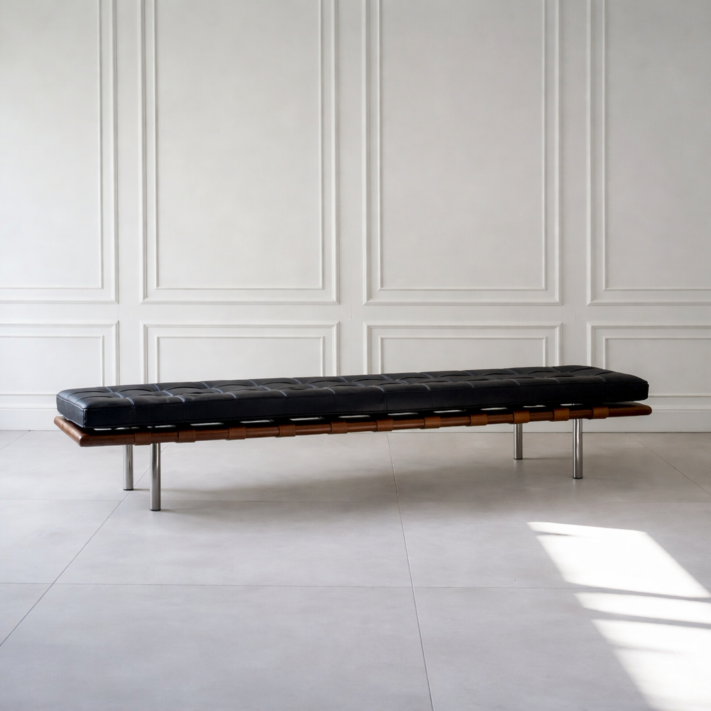 Black leather bench against a white paneled wall