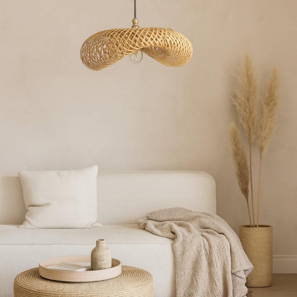 Cozy living room with a white sofa, woven ottoman, and rattan pendant light.