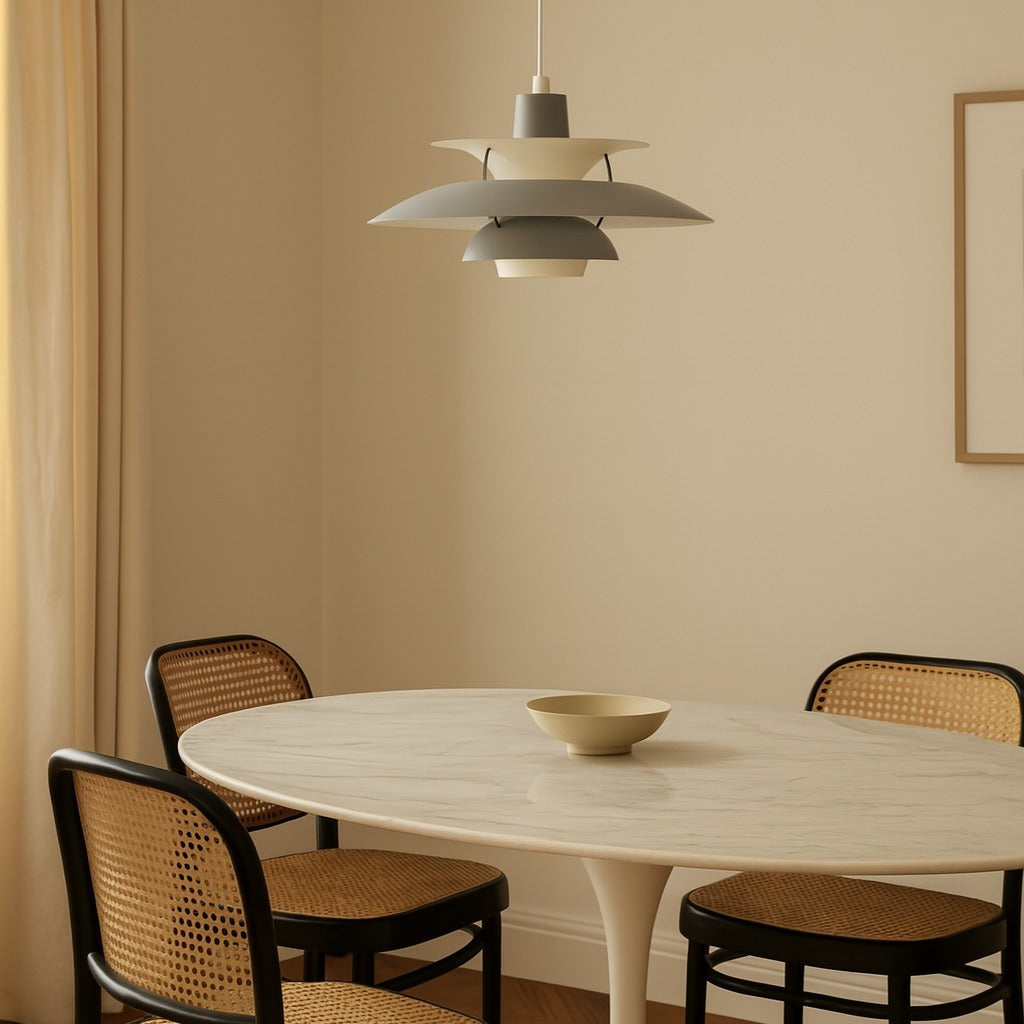 Dining room with a round table and chairs under a pendant light.